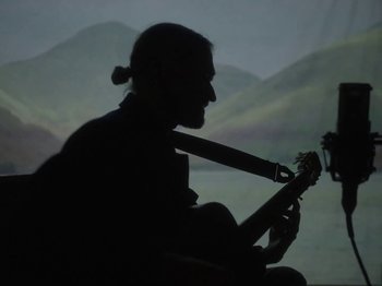 Movie still from “Hayden Thorpe - Aerial Songs” (2021), directed by Fiona Jane Burgess – Medium shot, Low angle