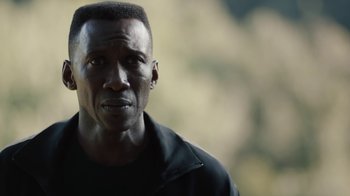 Movie still from “True Detective” (2014), created by Issa López – A person wearing a black jacket; Close Up shot, Over the shoulder angle