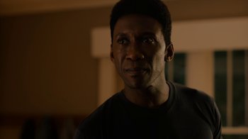 Movie still from “True Detective” (2014), created by Issa López – A person wearing a black t - shirt; Close Up shot, Over the shoulder angle