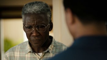 Movie still from “True Detective” (2014), created by Issa López – An older man wearing glasses looking at a younger man; Close Up shot, Over the shoulder angle
