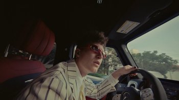 Movie still from “Gus Dapperton - Palms feat. Channel Tres” (2021), directed by Kevin Lombardo – Medium shot, Low angle