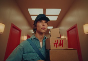 Movie still from “H&M - House of Members” (2023) – Medium shot, Low angle