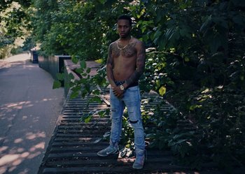Movie still from “J. Cole - #LoveYourz” (2018) – Medium shot, Low angle