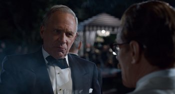 Movie still from “Trumbo” (2015), directed by Jay Roach – A man in a tuxedo talking to another man in a suit; Close Up shot, Over the shoulder angle