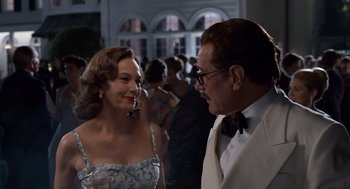 Movie still from “Trumbo” (2015), directed by Jay Roach – A man and a woman talking to each other in front of a crowd; Medium shot, Over the shoulder angle