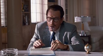 Movie still from “Trumbo” (2015), directed by Jay Roach – A man in a suit and tie writing on a piece of paper; Close Up shot, Over the shoulder angle