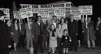 Movie still from “Trumbo” (2015), directed by Jay Roach – A black and white photo of a group of people holding signs; Wide shot, High angle