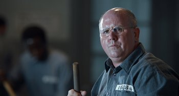 Movie still from “Trumbo” (2015), directed by Jay Roach – A man with glasses holding a stick in his hand; Close Up shot, Over the shoulder angle