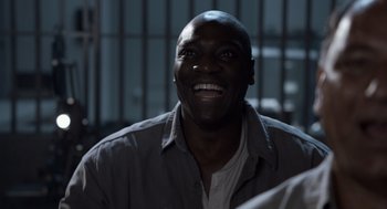 Movie still from “Trumbo” (2015), directed by Jay Roach – A man smiling in front of a jail cell; Close Up shot, High angle