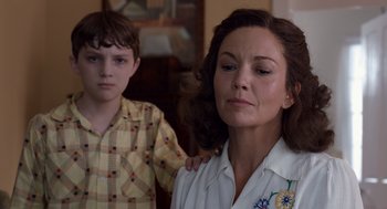 Movie still from “Trumbo” (2015), directed by Jay Roach – A woman and a young boy standing next to each other; Close Up shot, Low angle