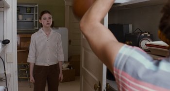 Movie still from “Trumbo” (2015), directed by Jay Roach – A man and a woman playing a game of basketball in a living room; Medium shot, Over the shoulder angle