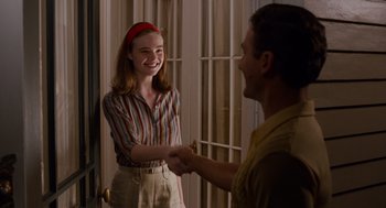 Movie still from “Trumbo” (2015), directed by Jay Roach – A man and a woman shaking hands in a room; Medium shot, Over the shoulder angle
