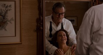 Movie still from “Trumbo” (2015), directed by Jay Roach – An older man and a younger woman in front of a mirror; Medium shot, Over the shoulder angle
