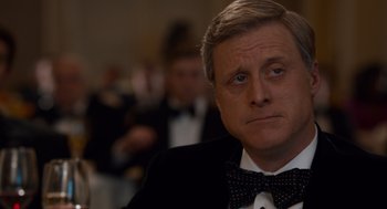 Movie still from “Trumbo” (2015), directed by Jay Roach – A person wearing a suit and a bow tie; Close Up shot, Over the shoulder angle