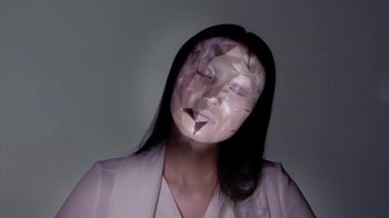 Movie still from “OMOTE - REAL-TIME FACE TRACKING & PROJECTION MAPPING” (2014) – Extreme Close Up shot, Low angle
