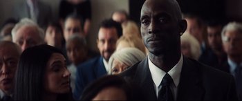 A group of people in suits and ties sitting in a room