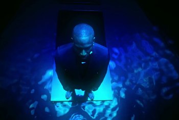 Movie still from “Nike - Skepta SkAir Air Max Tailwind V” (2021) – Medium shot, High angle