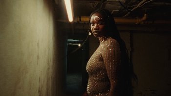 Movie still from “Abby T - Legos ft. Rodney Chrome” (2021), directed by Henry DaCosta – Medium shot, Low angle