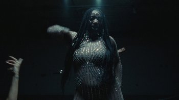 Movie still from “Abby T - Legos ft. Rodney Chrome” (2021), directed by Henry DaCosta – Medium shot, Low angle