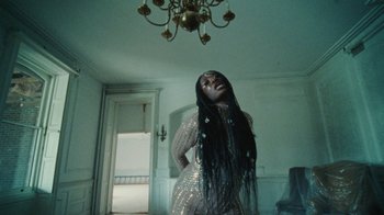 Movie still from “Abby T - Legos ft. Rodney Chrome” (2021), directed by Henry DaCosta – Medium shot, Low angle