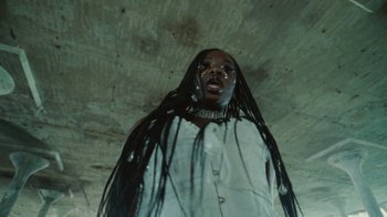 Movie still from “Abby T - Legos ft. Rodney Chrome” (2021), directed by Henry DaCosta – Close Up shot, Low angle