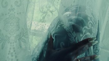 Movie still from “Abby T - Legos ft. Rodney Chrome” (2021), directed by Henry DaCosta – Extreme Close Up shot, Overhead angle