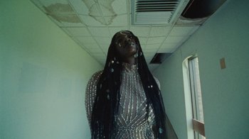 Movie still from “Abby T - Legos ft. Rodney Chrome” (2021), directed by Henry DaCosta – Medium shot, Low angle