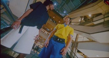 Movie still from “24kGoldn & Lil Tecca - Prada” (2021), directed by John Tashiro – Medium shot, Low angle