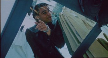 Movie still from “24kGoldn & Lil Tecca - Prada” (2021), directed by John Tashiro – Medium shot, Low angle