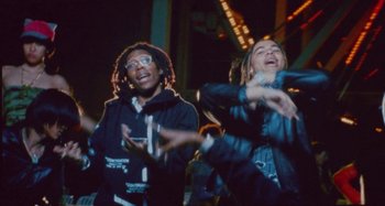 Movie still from “24kGoldn & Lil Tecca - Prada” (2021), directed by John Tashiro – Medium shot, Low angle