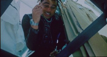 Movie still from “24kGoldn & Lil Tecca - Prada” (2021), directed by John Tashiro – Close Up shot, Overhead angle