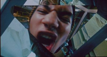 Movie still from “24kGoldn & Lil Tecca - Prada” (2021), directed by John Tashiro – Extreme Close Up shot, Overhead angle