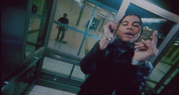 Movie still from “24kGoldn & Lil Tecca - Prada” (2021), directed by John Tashiro – Medium shot, Low angle