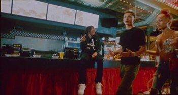 Movie still from “24kGoldn & Lil Tecca - Prada” (2021), directed by John Tashiro – Medium shot, Low angle