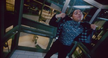 Movie still from “24kGoldn & Lil Tecca - Prada” (2021), directed by John Tashiro – Medium shot, Low angle