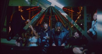 Movie still from “24kGoldn & Lil Tecca - Prada” (2021), directed by John Tashiro – Medium shot, Low angle