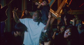 Movie still from “24kGoldn & Lil Tecca - Prada” (2021), directed by John Tashiro – Medium shot, Low angle