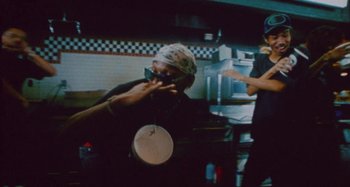 Movie still from “24kGoldn & Lil Tecca - Prada” (2021), directed by John Tashiro – Medium shot, Low angle