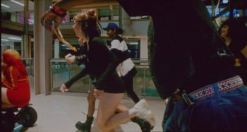 Movie still from “24kGoldn & Lil Tecca - Prada” (2021), directed by John Tashiro – Medium shot, High angle