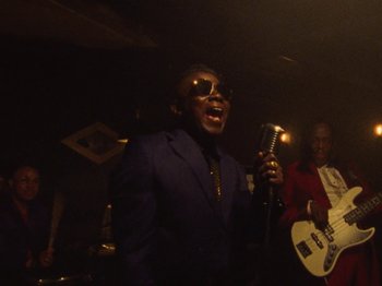 Movie still from “Earth, Wind & Fire - You Want My Love” (2021), directed by Andrew Litten – Medium shot, Low angle