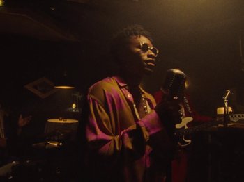 Movie still from “Earth, Wind & Fire - You Want My Love” (2021), directed by Andrew Litten – Medium shot, Low angle