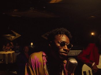 Movie still from “Earth, Wind & Fire - You Want My Love” (2021), directed by Andrew Litten – Medium shot, Low angle