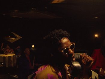 Movie still from “Earth, Wind & Fire - You Want My Love” (2021), directed by Andrew Litten – Medium shot, Low angle