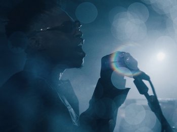 Movie still from “Earth, Wind & Fire - You Want My Love” (2021), directed by Andrew Litten – Extreme Close Up shot, Low angle