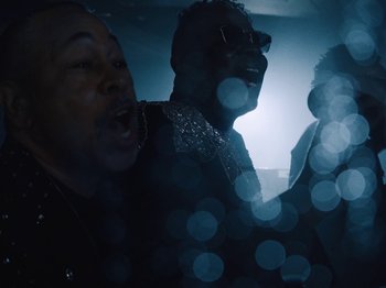 Movie still from “Earth, Wind & Fire - You Want My Love” (2021), directed by Andrew Litten – Medium shot, Low angle