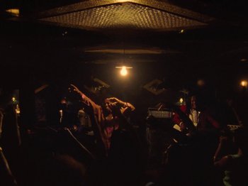 Movie still from “Earth, Wind & Fire - You Want My Love” (2021), directed by Andrew Litten – Medium shot, Low angle