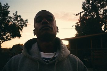 Movie still from “Huey Briss & Nikobeats - Grace Park Legend” (2021), directed by Michael Priestley – Close Up shot, Low angle
