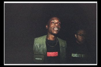 Movie still from “Huey Briss & Nikobeats - Grace Park Legend” (2021), directed by Michael Priestley – Medium shot, Low angle