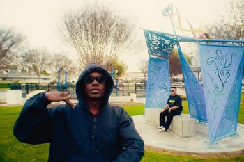 Movie still from “Huey Briss & Nikobeats - Grace Park Legend” (2021), directed by Michael Priestley – Wide shot, Low angle