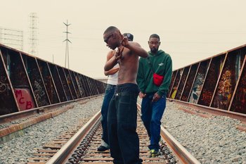 Movie still from “Huey Briss & Nikobeats - Grace Park Legend” (2021), directed by Michael Priestley – Medium shot, Low angle